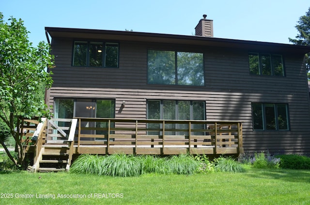 2397 Emerald Forest Cir Unit 26, East Lansing, MI 48823 - rear view of house with a wooden deck, a yard, and a chimney