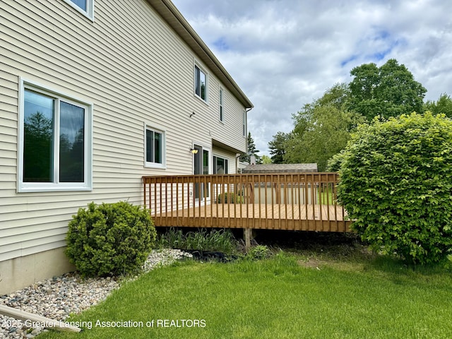 1512 Lindy Dr, Lansing, MI 48917 - back of house with a deck and a lawn