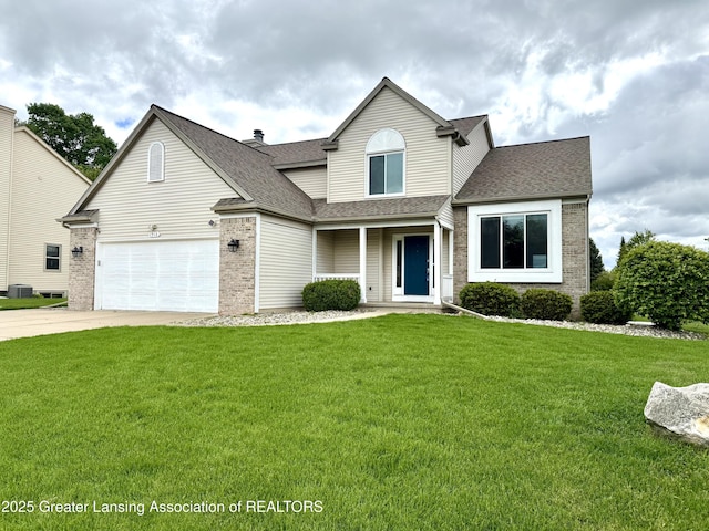 1512 Lindy Dr, Lansing, MI 48917 - traditional-style house featuring brick siding, a shingled roof, a front yard, and concrete driveway