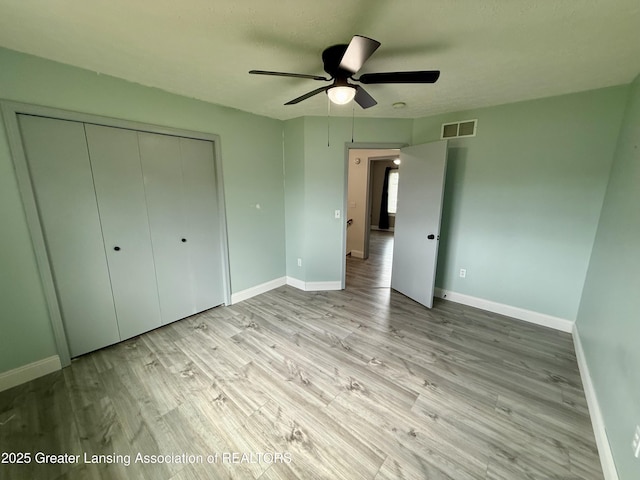 1512 Lindy Dr, Lansing, MI 48917 - unfurnished bedroom with light wood-style flooring, baseboards, a closet, and ceiling fan