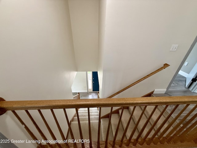 1512 Lindy Dr, Lansing, MI 48917 - stairway featuring wood finished floors and baseboards