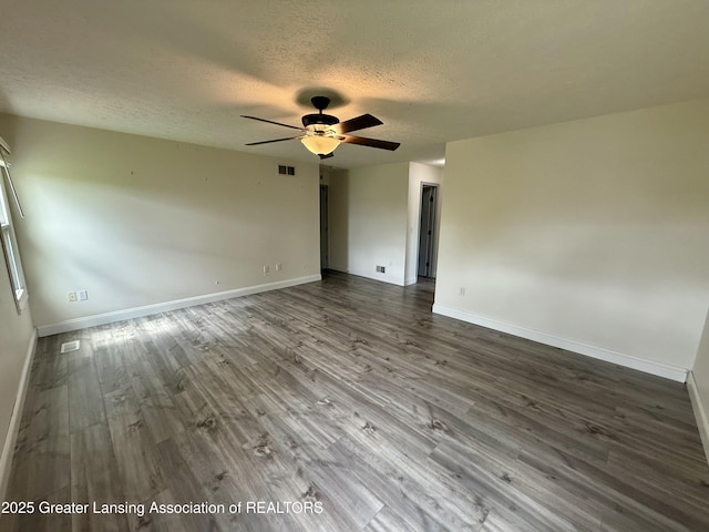 1512 Lindy Dr, Lansing, MI 48917 - unfurnished room with a textured ceiling, wood finished floors, a ceiling fan, and baseboards