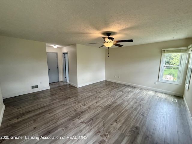 1512 Lindy Dr, Lansing, MI 48917 - unfurnished room featuring dark wood-style floors, a ceiling fan, a textured ceiling, and baseboards