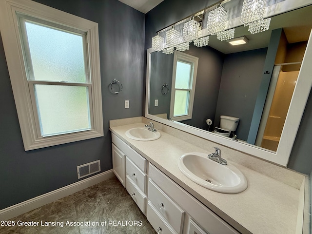 1512 Lindy Dr, Lansing, MI 48917 - full bathroom with double vanity, baseboards, toilet, and a shower