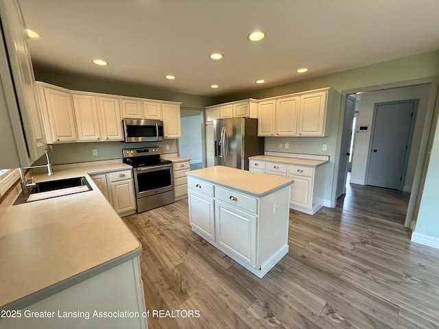 1512 Lindy Dr, Lansing, MI 48917 - kitchen featuring stainless steel appliances, recessed lighting, light countertops, a sink, and a center island