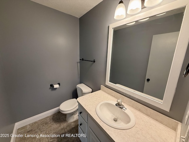 1512 Lindy Dr, Lansing, MI 48917 - half bath featuring vanity, toilet, a textured ceiling, and baseboards