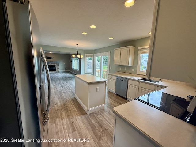 1512 Lindy Dr, Lansing, MI 48917 - kitchen featuring appliances with stainless steel finishes, recessed lighting, a center island, light countertops, and light wood-style flooring