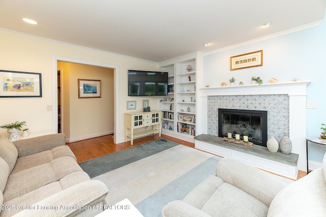 4767 Mohican Ln, Okemos, MI 48864 - living area with wood finished floors, crown molding, a fireplace, baseboards, and recessed lighting