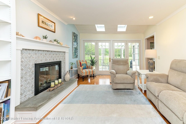 4767 Mohican Ln, Okemos, MI 48864 - living room with wood finished floors, ornamental molding, a fireplace, recessed lighting, and vaulted ceiling