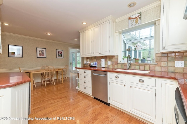 4767 Mohican Ln, Okemos, MI 48864 - kitchen with dishwasher, a sink, crown molding, light wood-style floors, and white cabinets