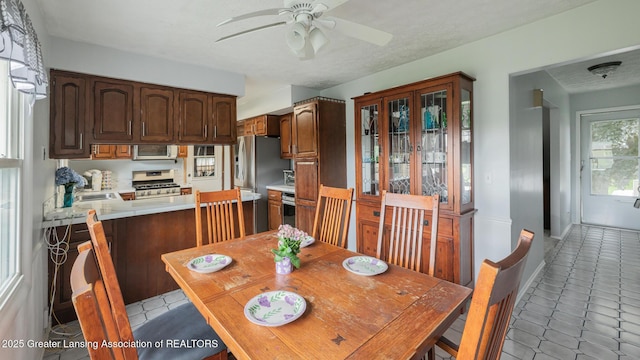 515 Chanticleer Trl, Lansing, MI 48917 - dining space featuring ceiling fan and light tile patterned flooring
