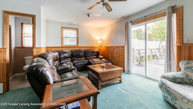 515 Chanticleer Trl, Lansing, MI 48917 - living area featuring wainscoting, ceiling fan, wooden walls, and carpet floors
