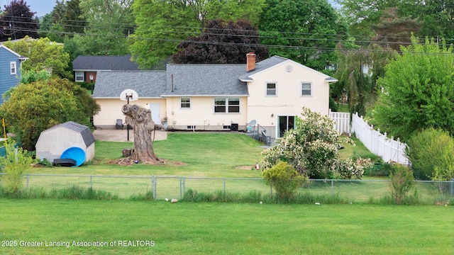 515 Chanticleer Trl, Lansing, MI 48917 - back of house featuring a chimney and roof with shingles