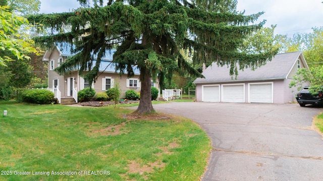 9181 Coleman Rd, Haslett, MI 48840 - view of front of property featuring a garage, driveway, and a front yard