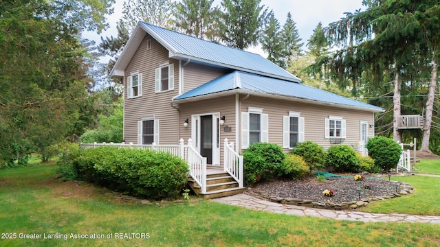 9181 Coleman Rd, Haslett, MI 48840 - view of front facade featuring a front lawn and metal roof