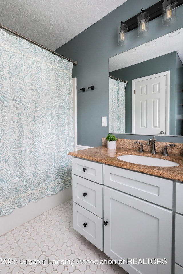9181 Coleman Rd, Haslett, MI 48840 - bathroom with vanity, a textured ceiling, and shower / tub combo