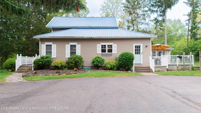9181 Coleman Rd, Haslett, MI 48840 - view of front of home featuring a deck and metal roof