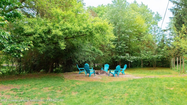 9181 Coleman Rd, Haslett, MI 48840 - view of green lawn with a fire pit
