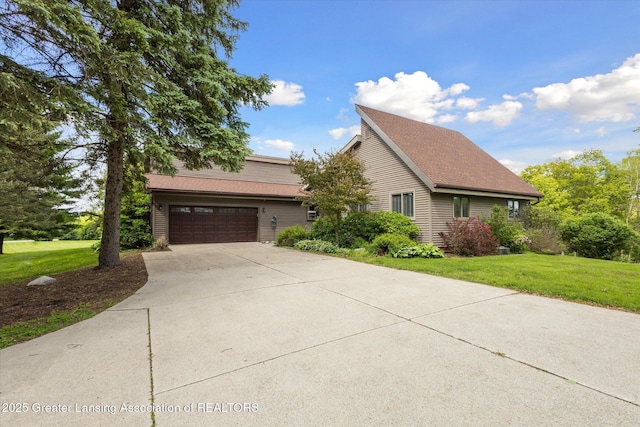 12560 Eaton Rapids Rd, Springport, MI 49284 - view of front of home featuring concrete driveway, a front yard, and a garage