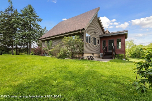 12560 Eaton Rapids Rd, Springport, MI 49284 - view of home's exterior featuring a lawn and a shingled roof