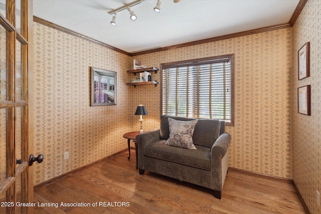 12560 Eaton Rapids Rd, Springport, MI 49284 - sitting room featuring wood-type flooring, rail lighting, crown molding, baseboards, and wallpapered walls