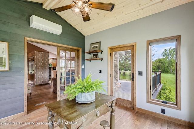 12560 Eaton Rapids Rd, Springport, MI 49284 - doorway with a wall unit AC, wood walls, vaulted ceiling, light wood-style floors, and a ceiling fan