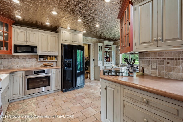 12560 Eaton Rapids Rd, Springport, MI 49284 - kitchen featuring black appliances, an ornate ceiling, light countertops, tasteful backsplash, and recessed lighting