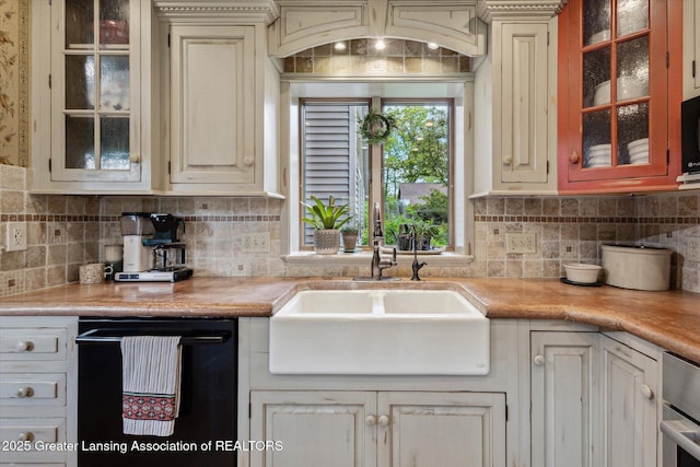 12560 Eaton Rapids Rd, Springport, MI 49284 - kitchen featuring a sink, light countertops, black appliances, and backsplash