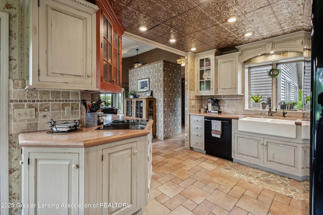 12560 Eaton Rapids Rd, Springport, MI 49284 - kitchen featuring black appliances, light countertops, a sink, decorative backsplash, and glass insert cabinets