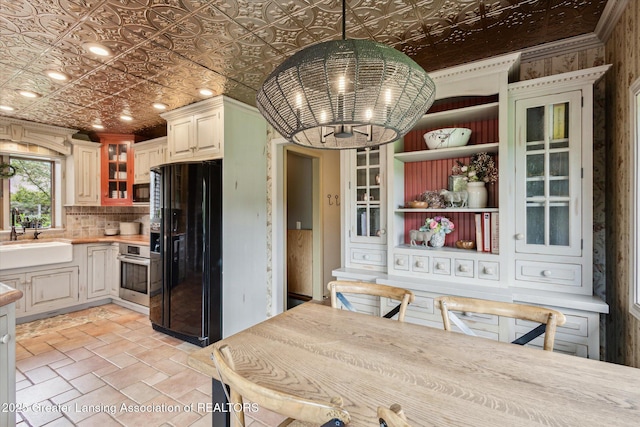 12560 Eaton Rapids Rd, Springport, MI 49284 - kitchen featuring black appliances, a sink, a chandelier, an ornate ceiling, and light countertops