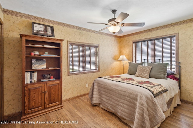12560 Eaton Rapids Rd, Springport, MI 49284 - bedroom with light wood-type flooring, baseboards, wallpapered walls, and a ceiling fan
