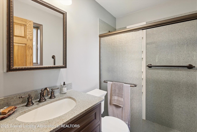 12560 Eaton Rapids Rd, Springport, MI 49284 - bathroom with a shower stall, vanity, and toilet