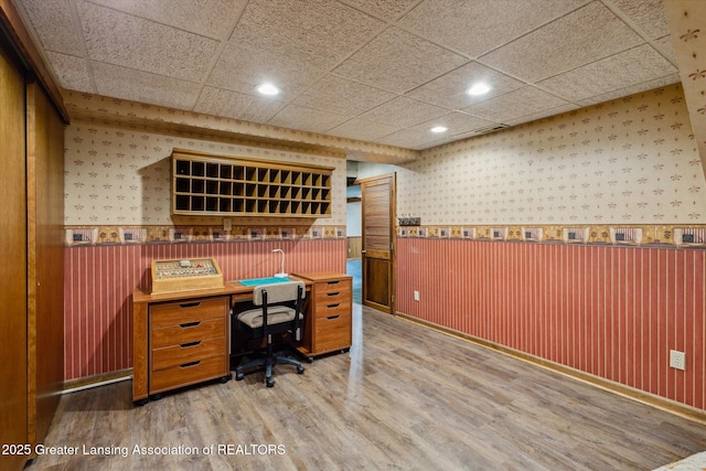12560 Eaton Rapids Rd, Springport, MI 49284 - home office featuring wallpapered walls, wood finished floors, recessed lighting, wainscoting, and baseboards