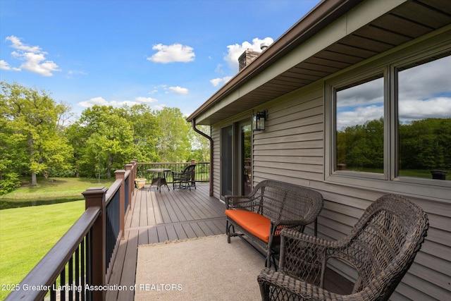 12560 Eaton Rapids Rd, Springport, MI 49284 - deck featuring a lawn, view of wooded area, and a water view