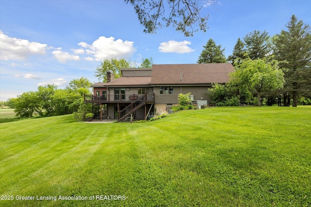 12560 Eaton Rapids Rd, Springport, MI 49284 - rear view of property with a deck, stairs, a lawn, and a chimney