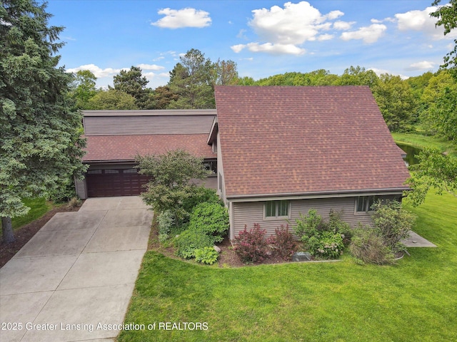 12560 Eaton Rapids Rd, Springport, MI 49284 - view of front of property with a front lawn, concrete driveway, a shingled roof, and an attached garage