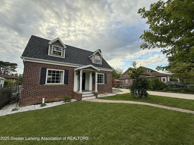 320 Elm St, Portland, MI 48875 - cape cod home featuring brick siding and roof with shingles
