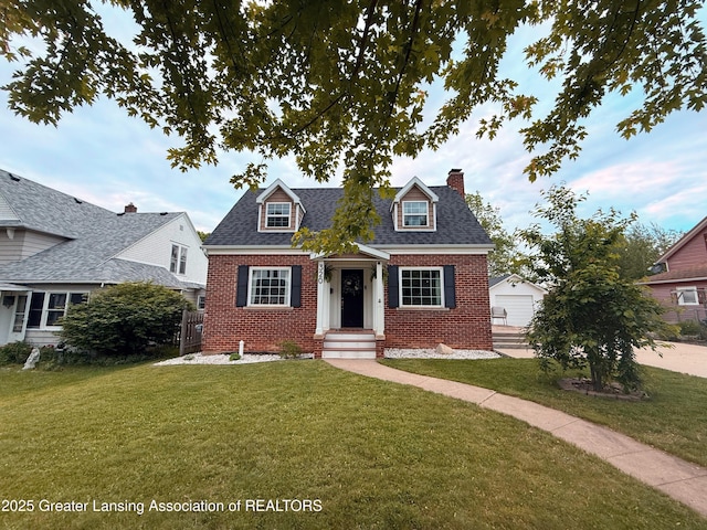 320 Elm St, Portland, MI 48875 - new england style home with brick siding, a chimney, an outdoor structure, and a shingled roof
