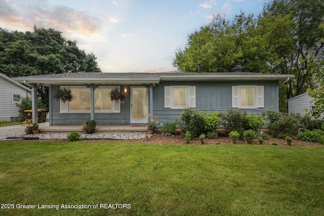 530 S Dibble Blvd, Lansing, MI 48917 - view of front facade featuring a yard, covered porch, and a chimney