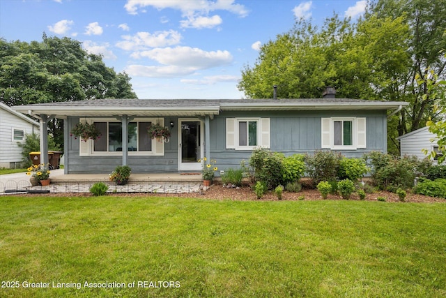 530 S Dibble Blvd, Lansing, MI 48917 - view of front of home featuring covered porch, a front yard, and a chimney