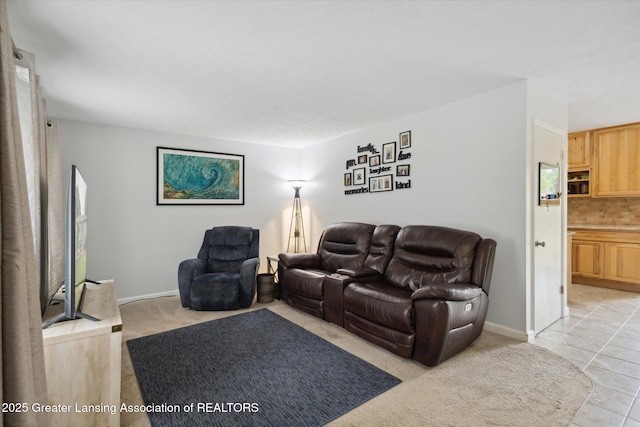530 S Dibble Blvd, Lansing, MI 48917 - living room featuring baseboards, light tile patterned floors, and light carpet