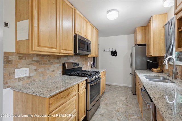 530 S Dibble Blvd, Lansing, MI 48917 - kitchen with appliances with stainless steel finishes, a sink, tasteful backsplash, and light stone countertops