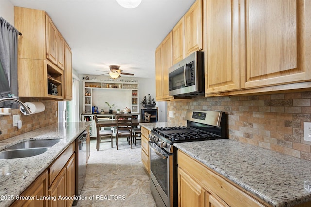530 S Dibble Blvd, Lansing, MI 48917 - kitchen with appliances with stainless steel finishes, a sink, backsplash, ceiling fan, and light stone countertops
