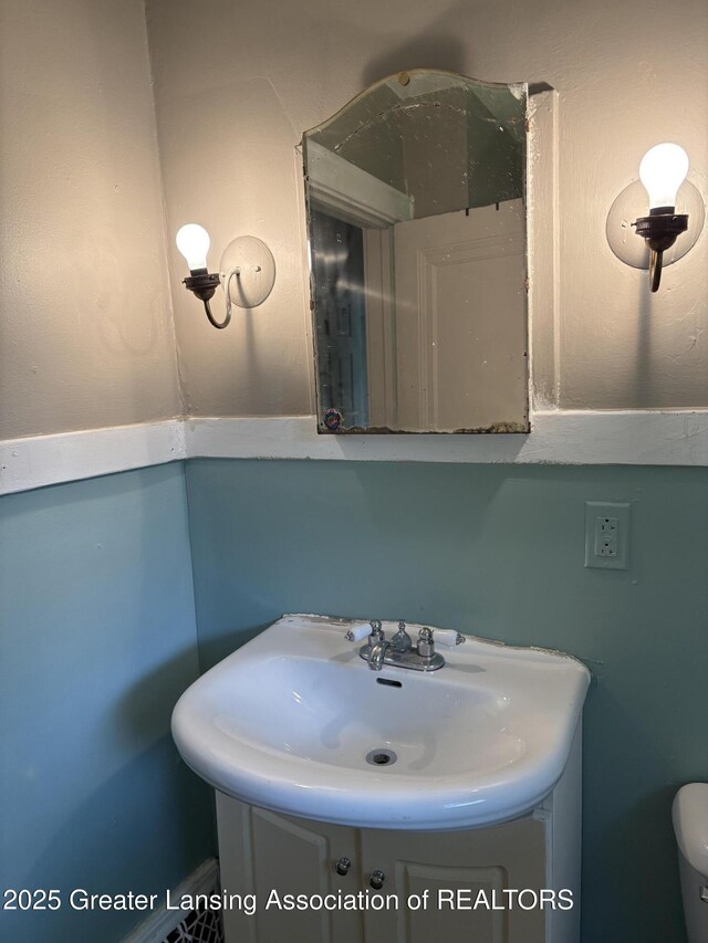 2113 S Rundle Ave, Lansing, MI 48910 - bathroom featuring vanity and toilet