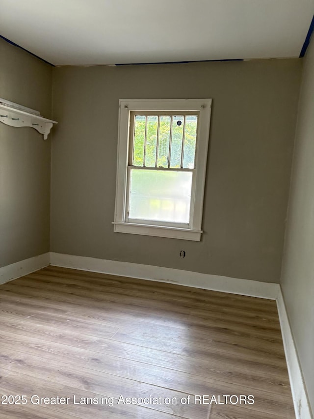 2113 S Rundle Ave, Lansing, MI 48910 - empty room with wood finished floors and baseboards