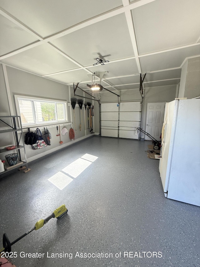 4412 Darron Dr, Lansing, MI 48917 - garage with freestanding refrigerator and a garage door opener