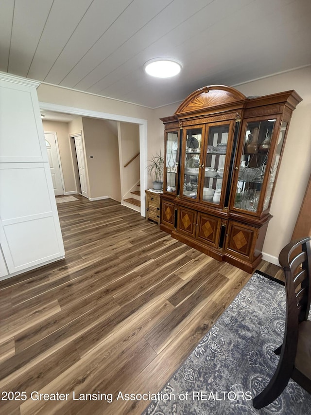 4412 Darron Dr, Lansing, MI 48917 - unfurnished dining area with wood finished floors, stairway, and baseboards