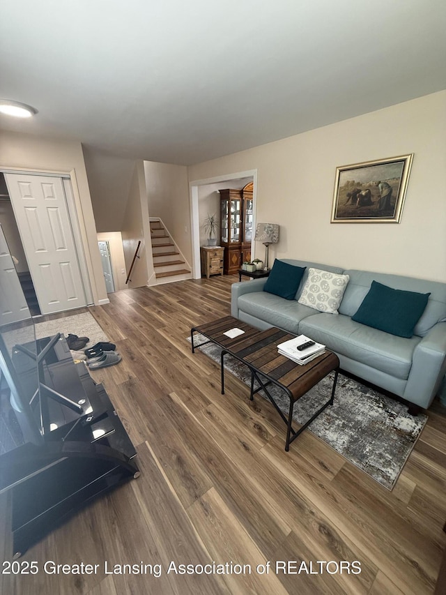4412 Darron Dr, Lansing, MI 48917 - living area featuring wood finished floors and stairs