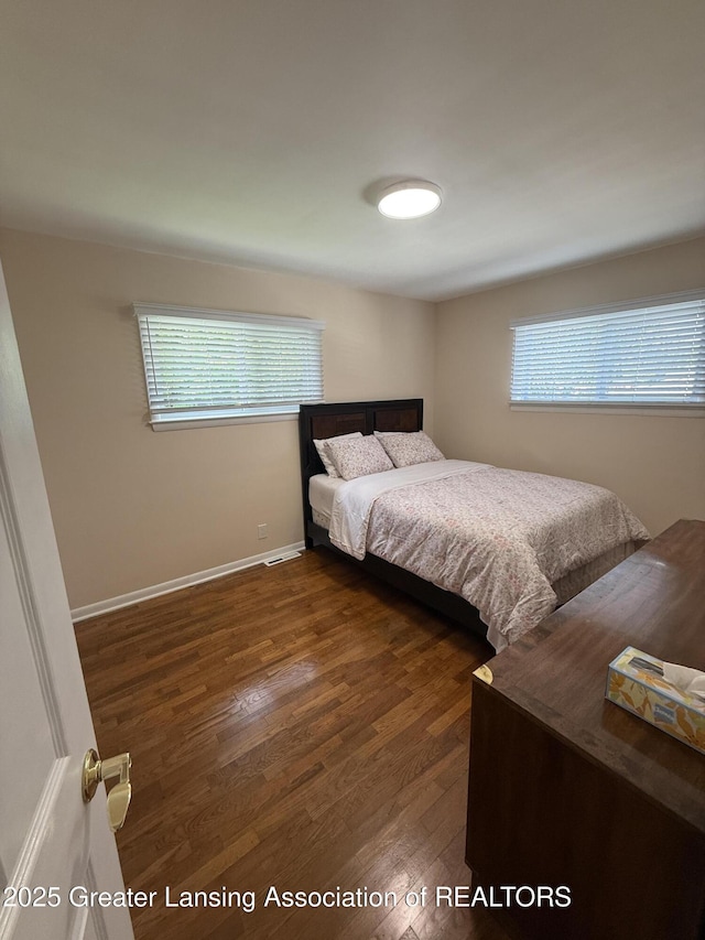 4412 Darron Dr, Lansing, MI 48917 - bedroom featuring wood finished floors, multiple windows, and baseboards