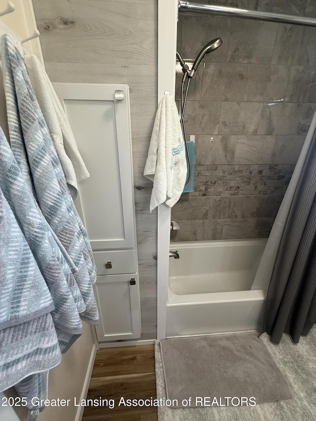 4412 Darron Dr, Lansing, MI 48917 - bathroom featuring shower / tub combo and wood finished floors